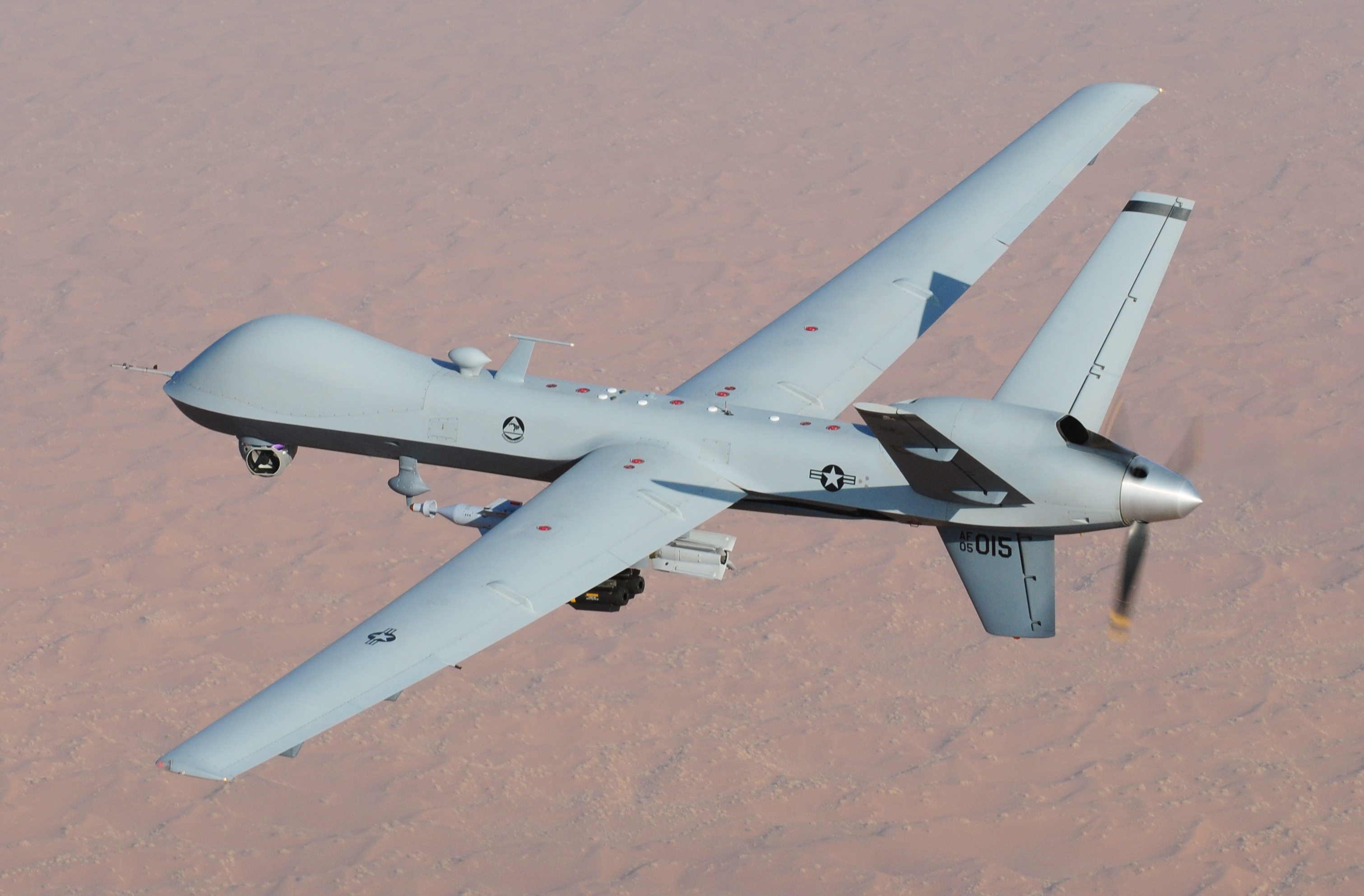 Military unmanned aerial vehicle in flight, representing robotic warfare technology